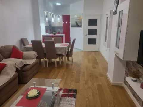 A bright, open-plan living room with an adjacent dining area and kitchen. - image 2