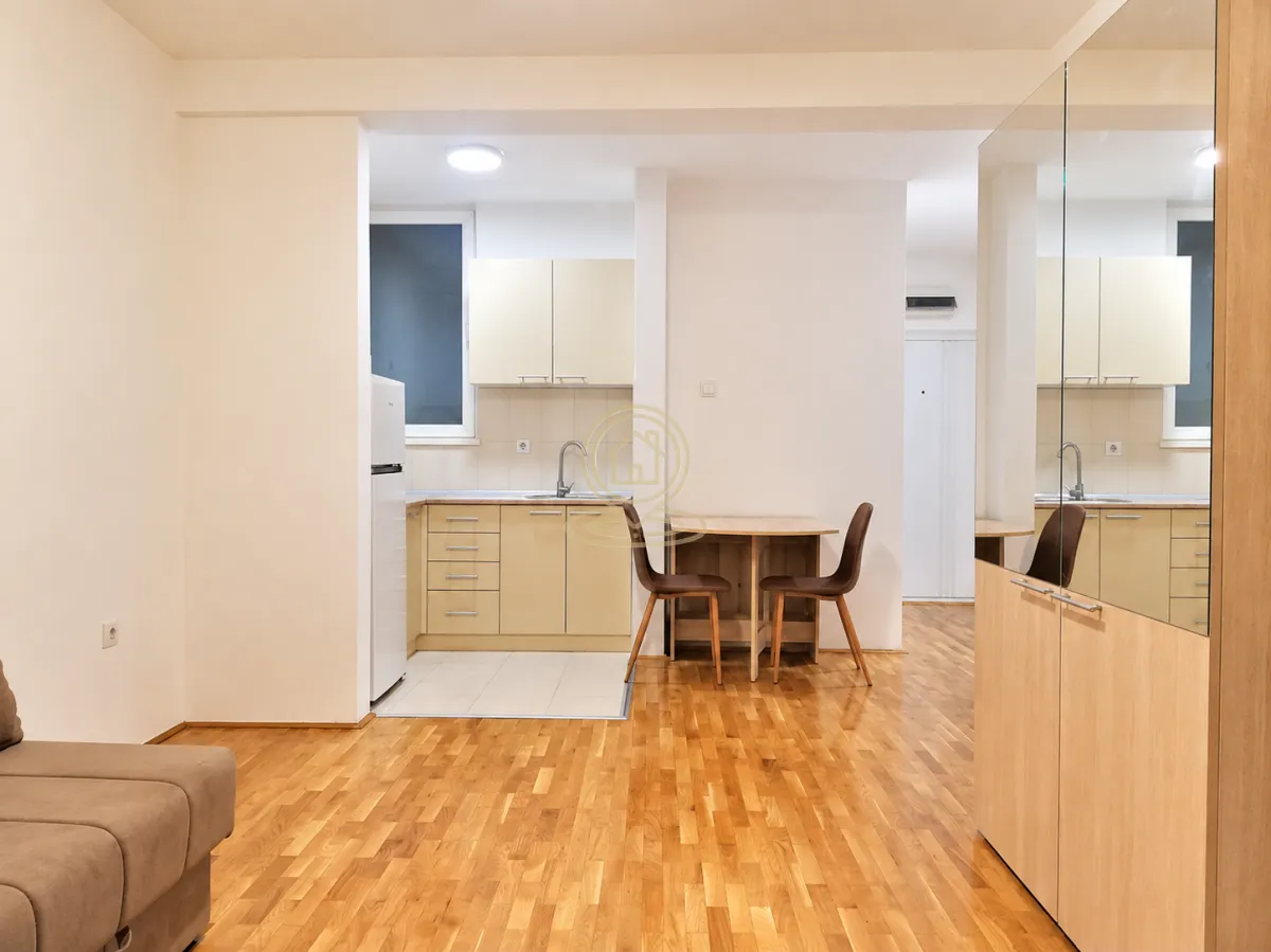 Smaller kitchen with a dining table and chairs connected to the living area.