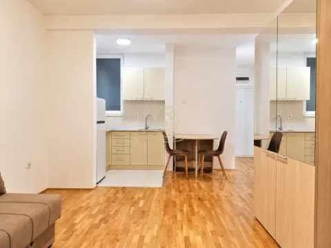 Smaller kitchen with a dining table and chairs connected to the living area. - image 3