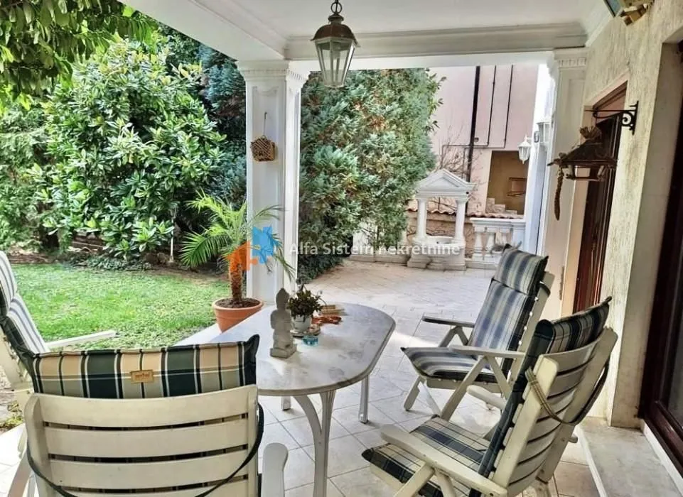 Covered terrace with a table and chairs overlooking the courtyard.