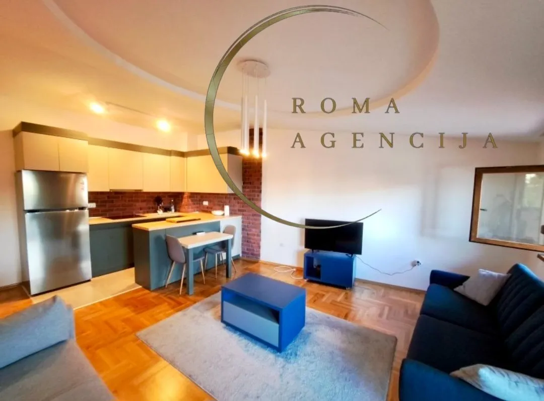Living room with kitchen and dining area in a modern apartment.