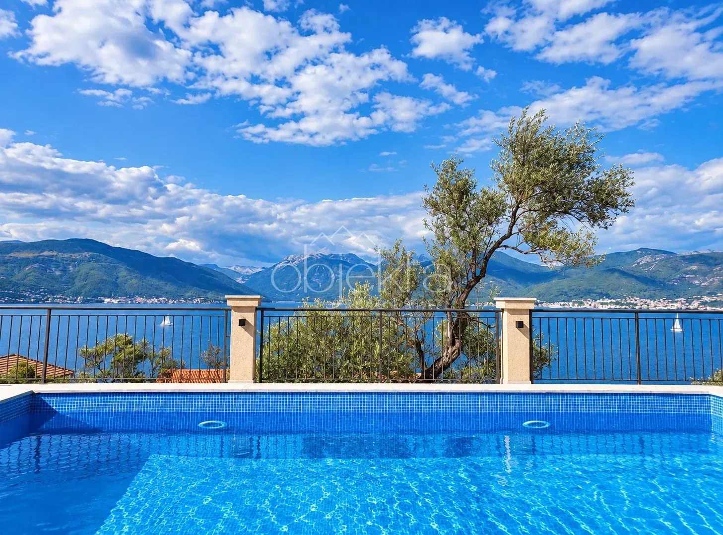 Swimming pool with a view of the sea and mountains.