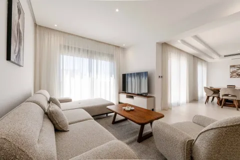 Modern bright living room with a sofa, wooden coffee table, and a TV. - image 14