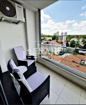 Furnished balcony with seating set and city view. - image 7