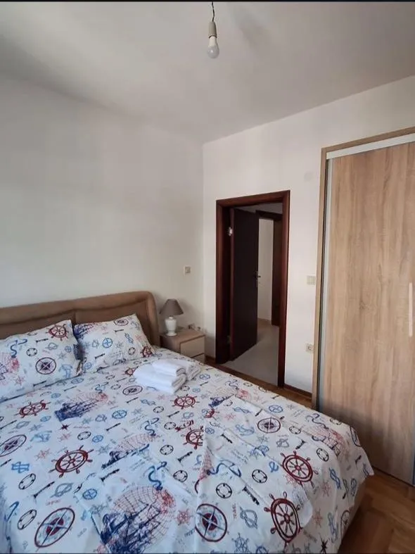 Furnished bedroom with a double bed and wardrobe.