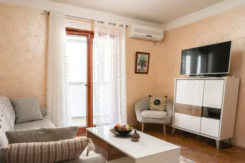 Living room with a sofa, TV cabinet, and access to the terrace. - image 3