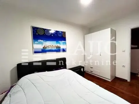 Bedroom with a double bed, white wardrobe, and a picture on the wall. - image 6
