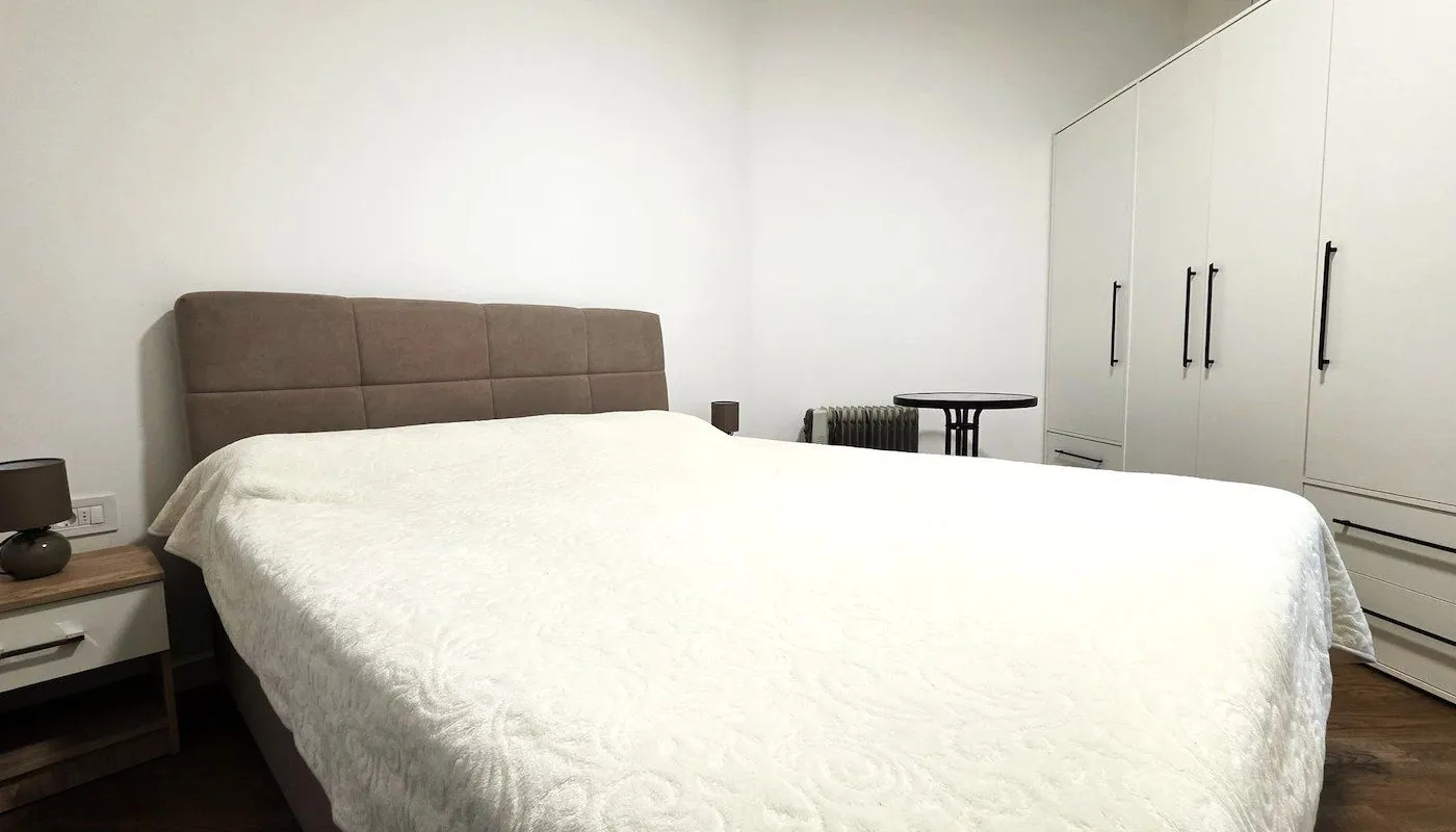 Bedroom with a double bed, wardrobe, and nightstand.