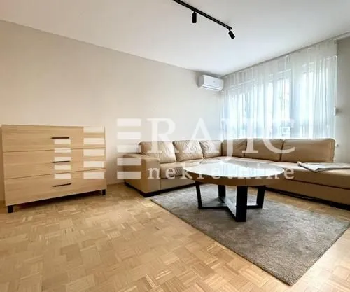 Living room with a sectional sofa, dresser, and coffee table.