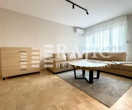Living room with a sectional sofa, dresser, and coffee table. - image 7