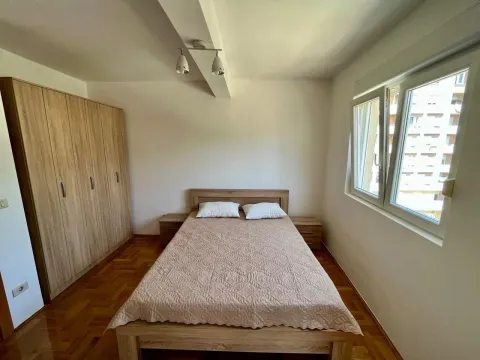 Furnished bedroom with a double bed, wardrobe, and parquet flooring. - image 6