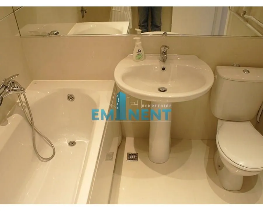 View of the bathroom with a bathtub, sink, and toilet.