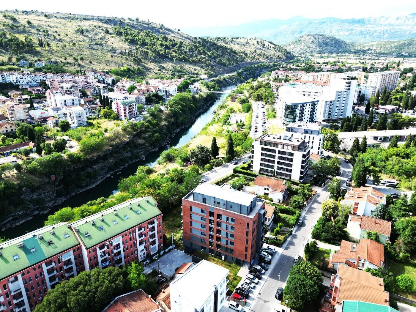 Aerial view of an urban neighborhood with buildings and a river.