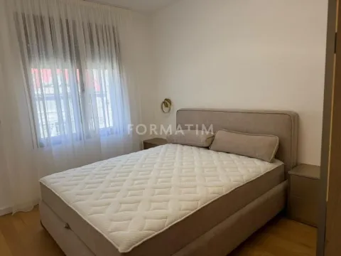 Bedroom with a double bed and a window with curtains. - image 17
