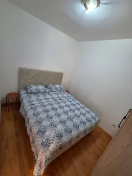 Bedroom with a double bed, wooden flooring, and white walls. - image 7