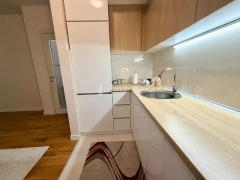 Modern kitchen with white cabinets and wooden countertops. - image 6