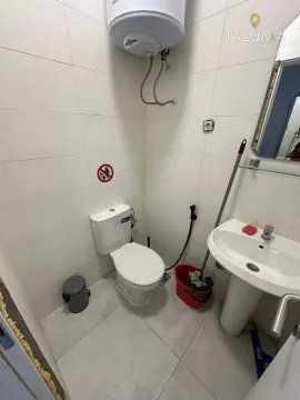Small bathroom with sanitary ware and a bidet hose. - image 2