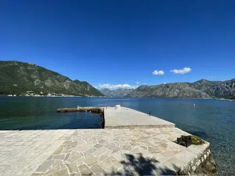 View of the sea and mountains from a paved terrace and pier. - image 11