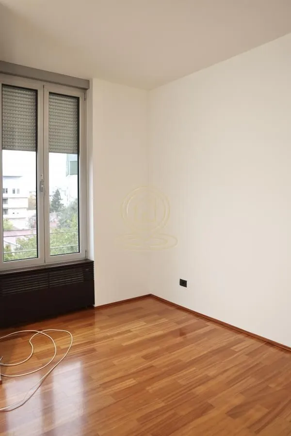 Empty room with hardwood floors and a window.
