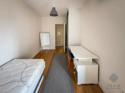 Small bedroom with a bed, desk, and wardrobe. - image 11
