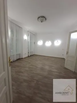 Empty room with laminate flooring and white walls. - image 5