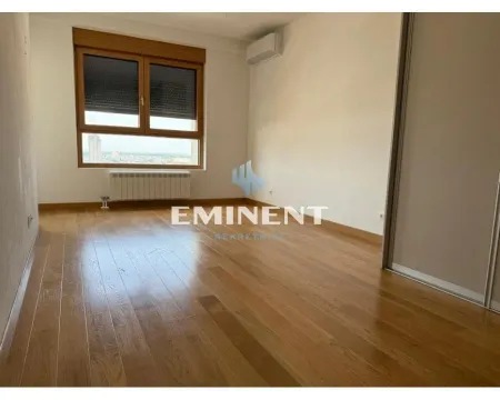 Empty room with wooden flooring, a window, and a built-in wardrobe. - image 9