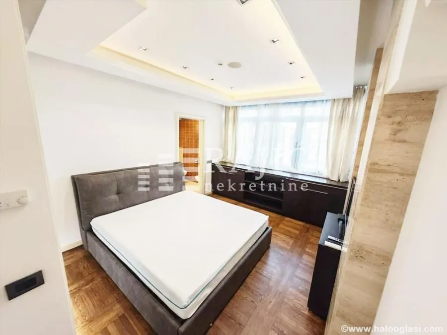 Spacious bedroom with a double bed and a dropped ceiling.