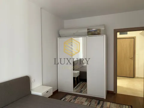 Furnished bedroom with a white wardrobe and a double bed. - image 7
