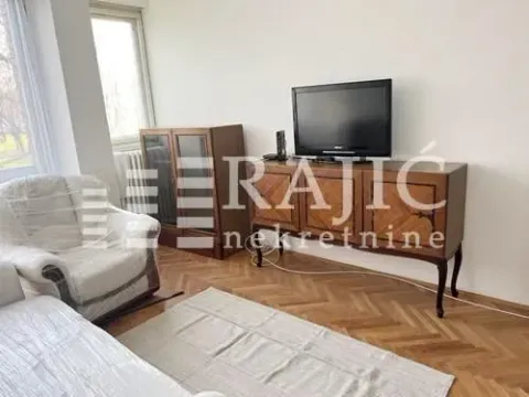 Living room with wooden furniture and a television. - image 2