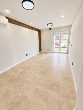 Empty bright room with tiled flooring and access to the terrace. - image 2