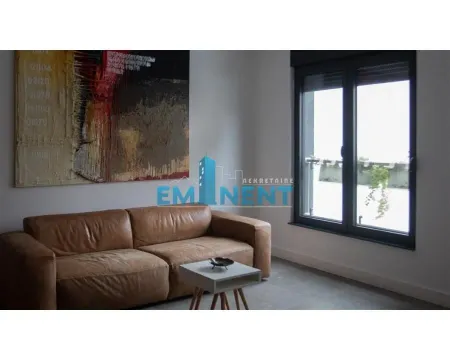 Living room with a leather sofa, coffee table, and a large artwork on the wall. - image 5