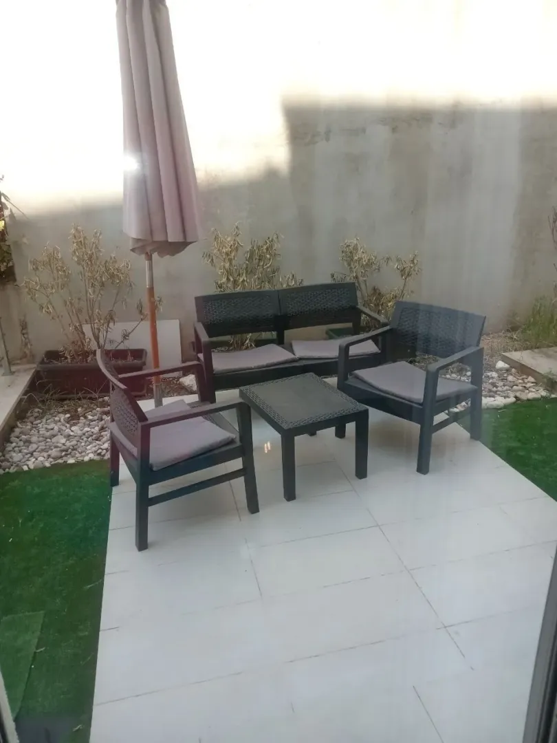 Terrace with outdoor seating furniture and a parasol.