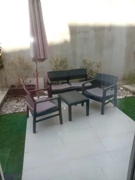 Terrace with outdoor seating furniture and a parasol. - image 12