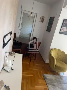 Living room with a dining area and parquet flooring. - image 2