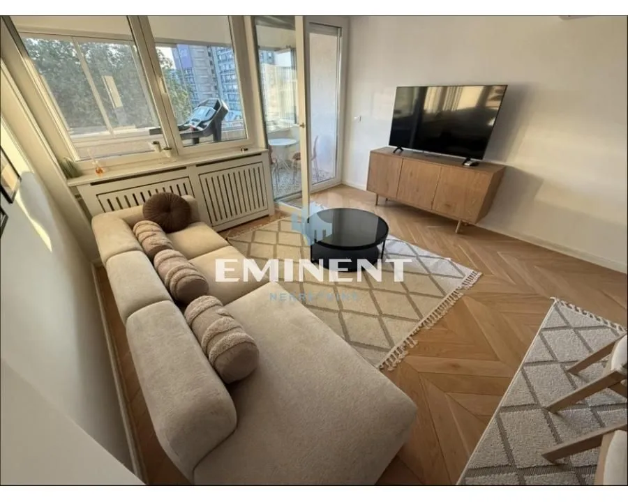 Living room with a sofa, TV, and access to the terrace.