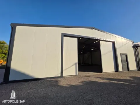Exterior of a prefabricated industrial hall with sliding doors and metal structure. - image 2