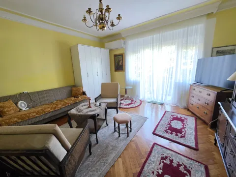Furnished living room with a sofa set, television, and parquet flooring. - image 2