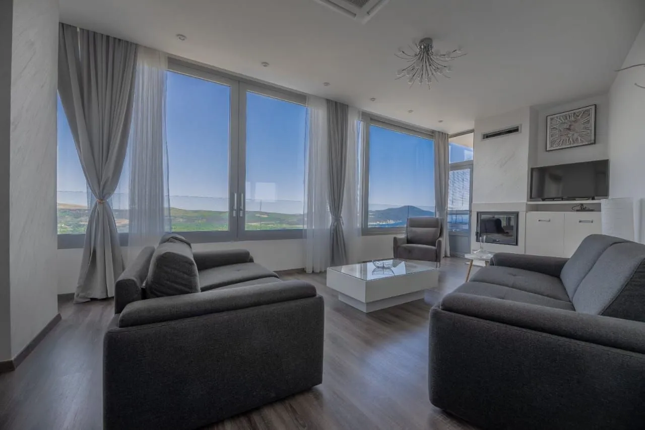 Spacious living room with large windows and nature view.