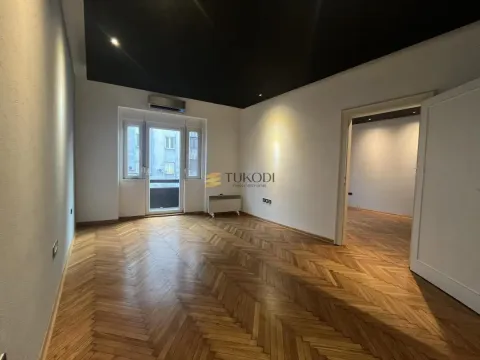 Empty room with hardwood parquet flooring, black ceiling, and access to a balcony. - image 8