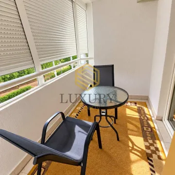 Enclosed balcony with seating furniture and a view of greenery. - image 4