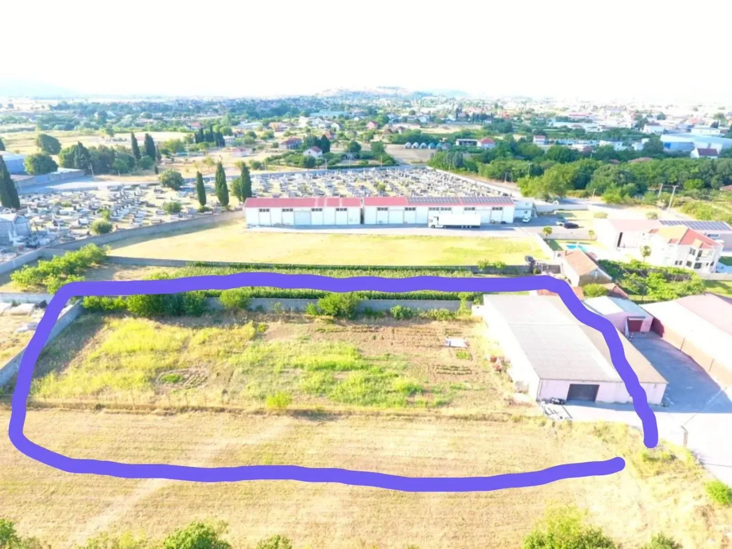 Aerial view of the land plot with marked borders.