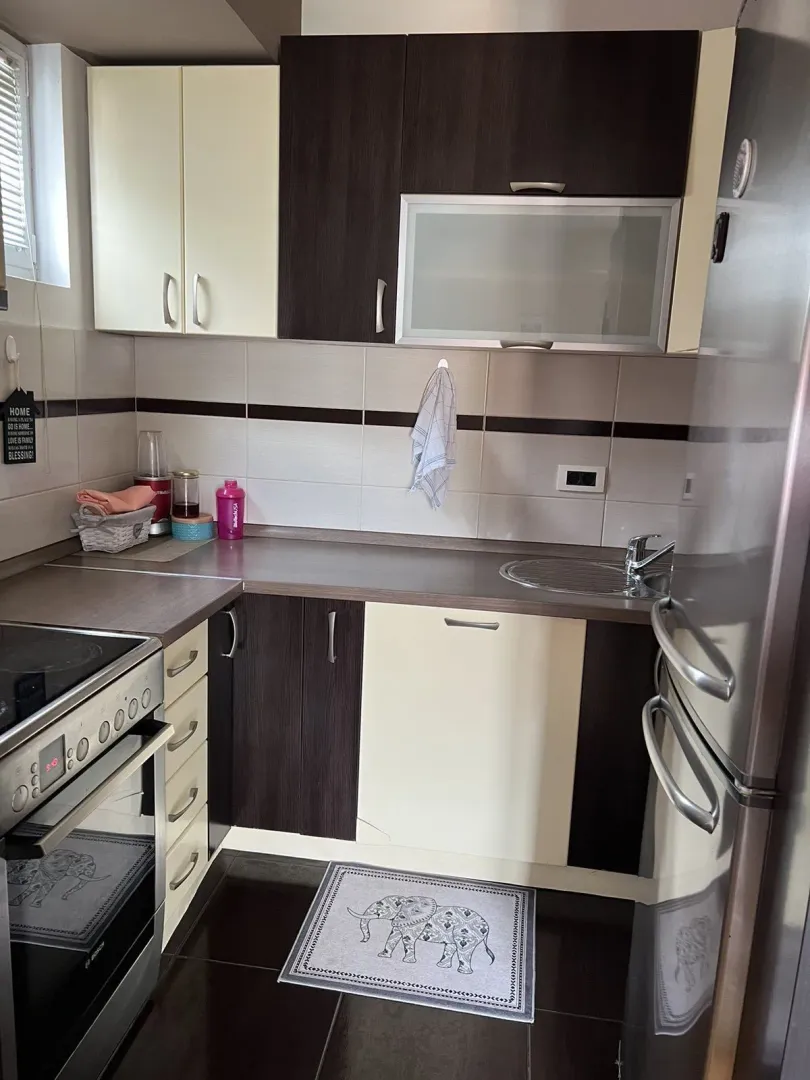 A practical kitchen featuring a combination of dark and light cabinets.
