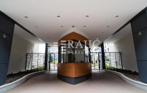 Entrance to a residential building with a security desk. - image 14