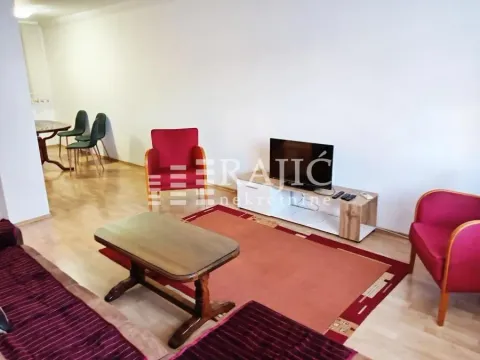 Living room with a seating set and a dining area in the background. - image 3