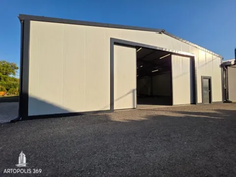 Exterior view of a modern prefabricated building with large sliding doors. - image 4