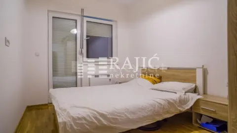 Furnished bedroom with a double bed and balcony access. - image 7