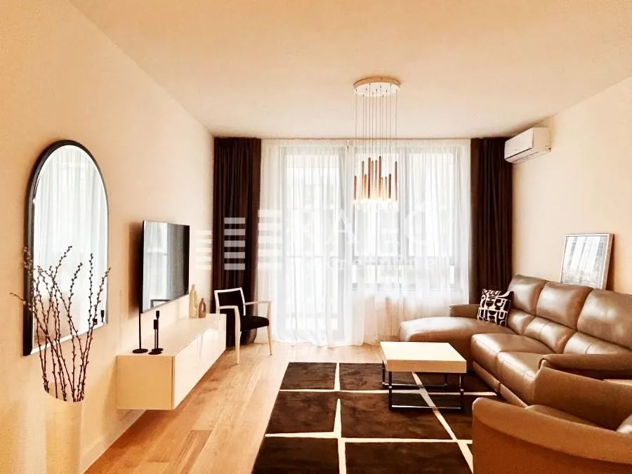 Modern and tidy living room with a sofa, TV, and decorative details.