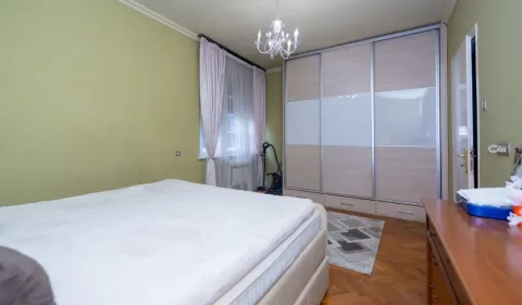 Bedroom with a double bed, large built-in wardrobe, and a window. - image 3