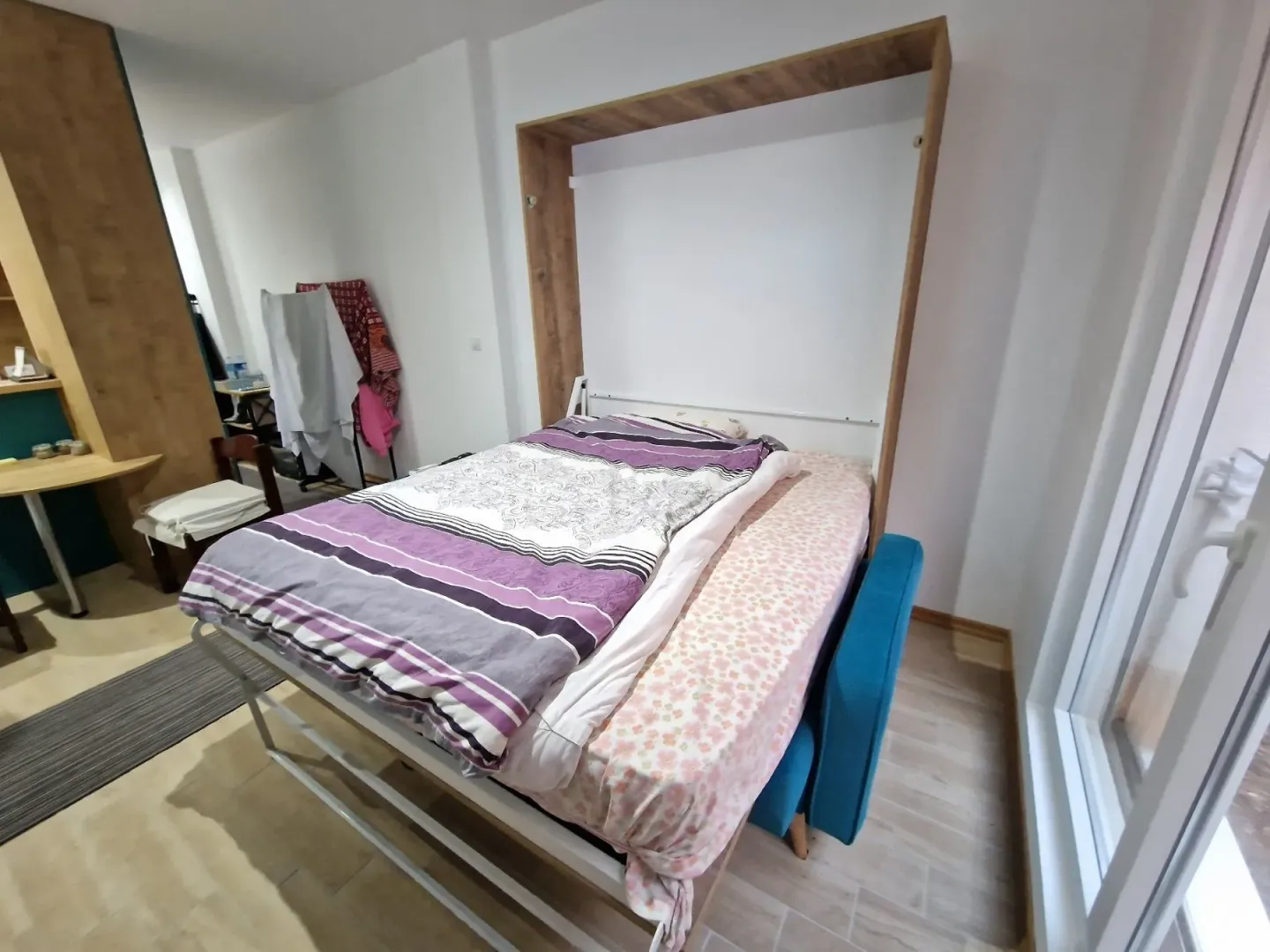 Bedroom with a fold-down bed and bedding.