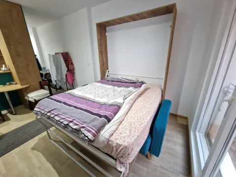 Bedroom with a fold-down bed and bedding. - image 11